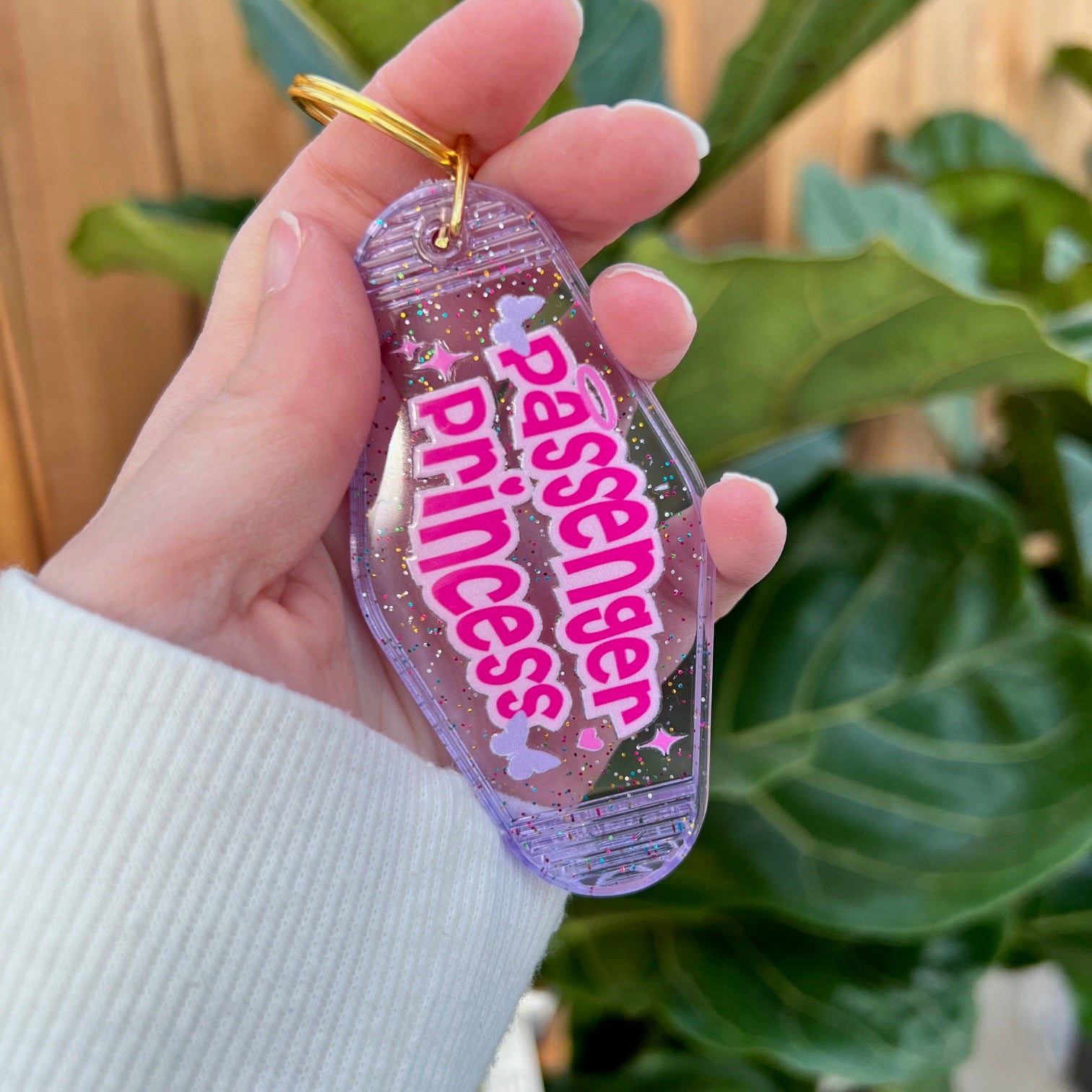 Motel inspired keychain with passenger princess written on it with butterflies and stars