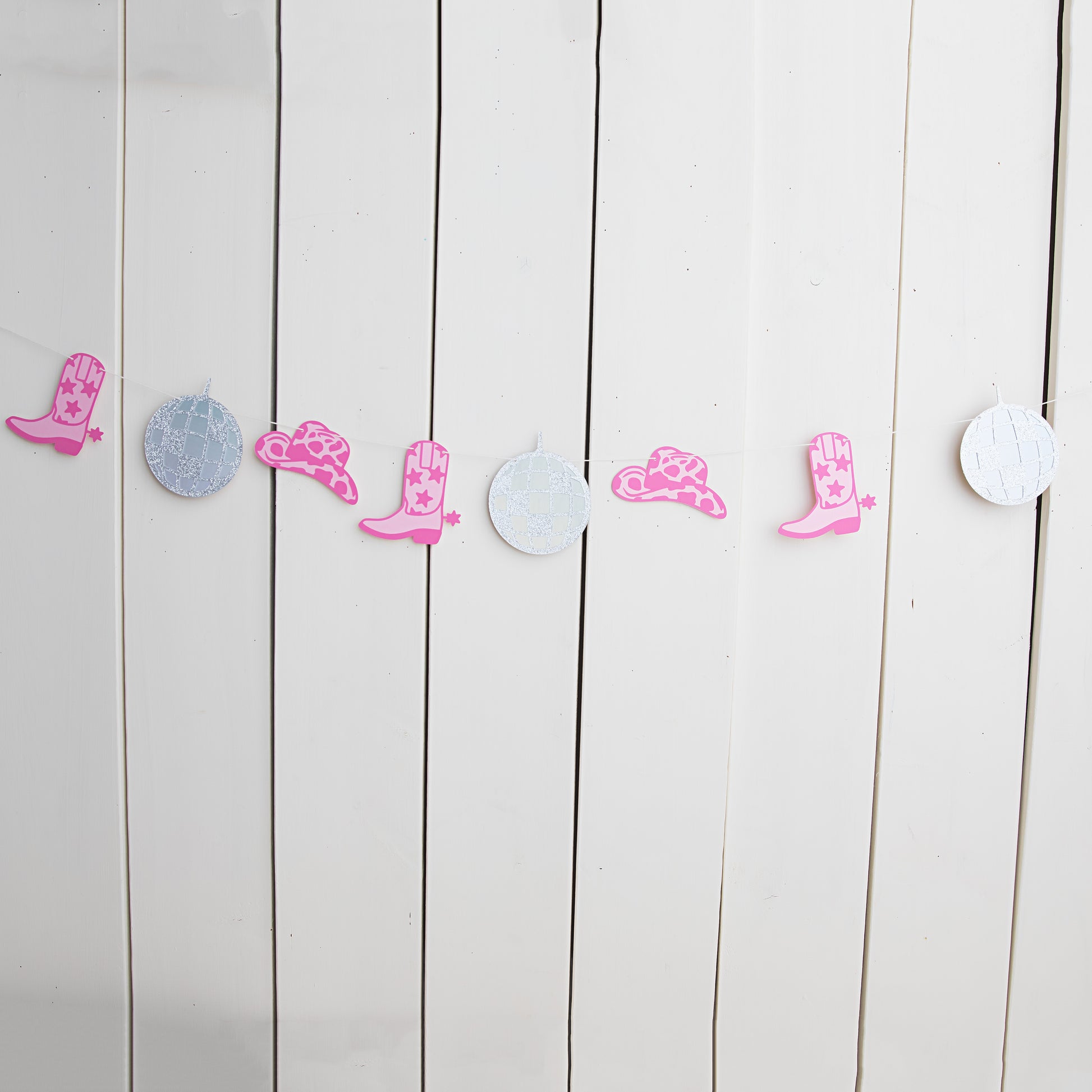 disco cowgirl garland with disco balls, cowgirl hats and pink cowboy boots