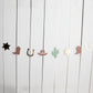 My first rodeo paper garland with cowboy boots, sheriff badges, cacti and cowboy hats