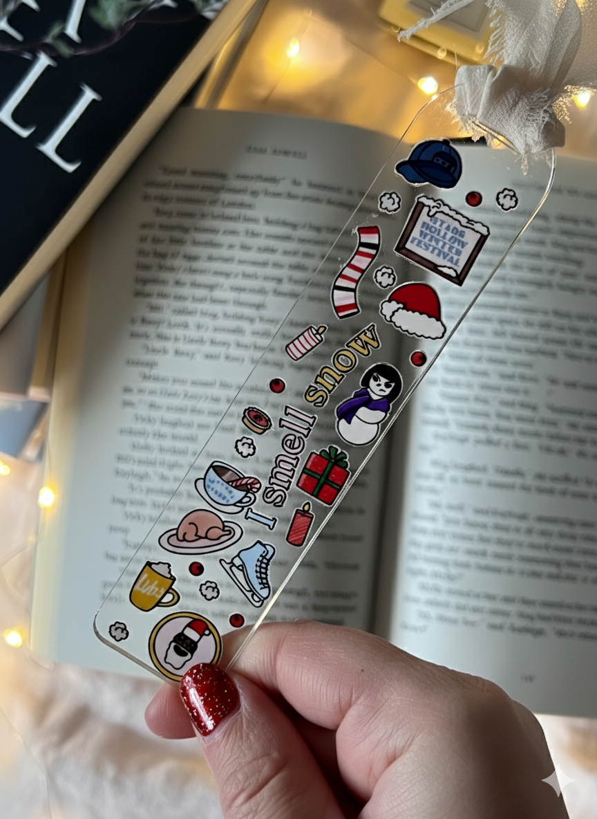 Decorative bookmark with Christmas-themed stickers held over an open book.